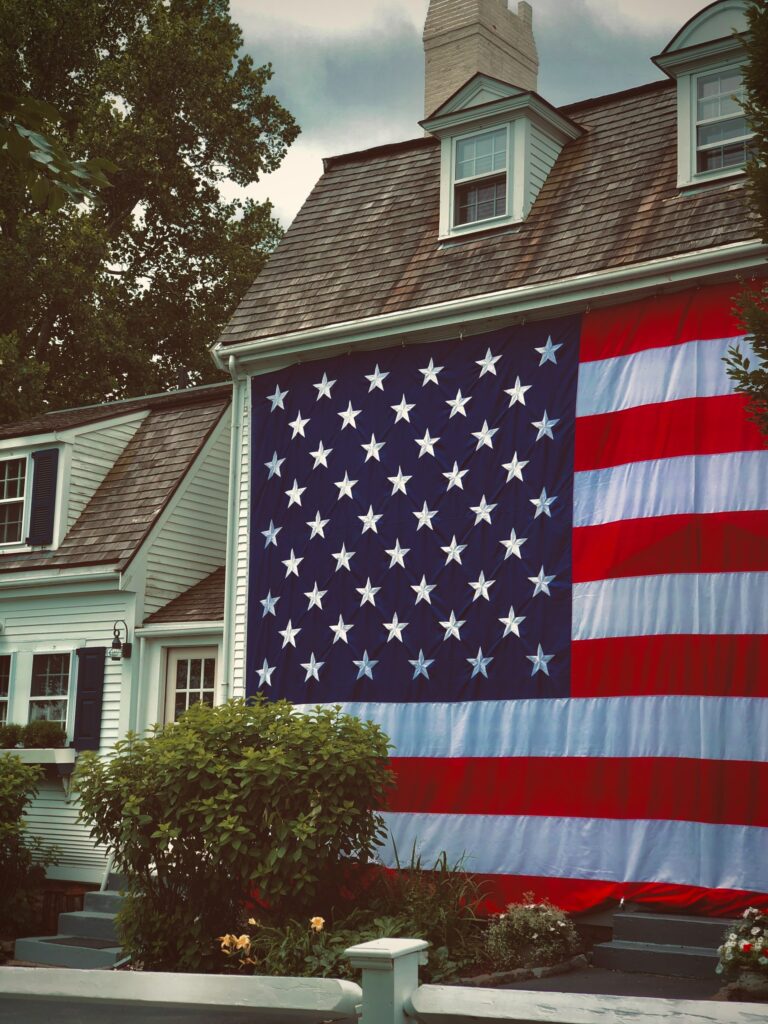 Flag of the USA on the side of a house in Plymouth, Massachusetts.